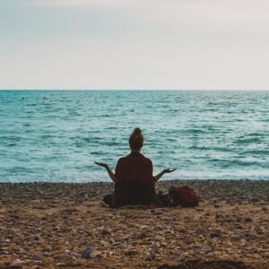 lady meditating on the beach