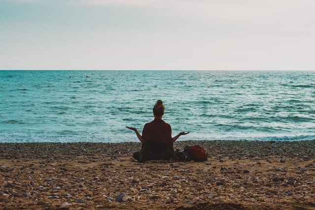 lady meditating on the beach lady meditating on the beach